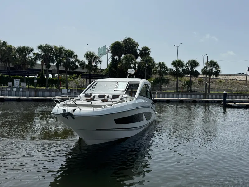 Slide: The Image of 2022 Beneteau Gran Turismo 32 yacht docked in a marina with palm trees. - 3