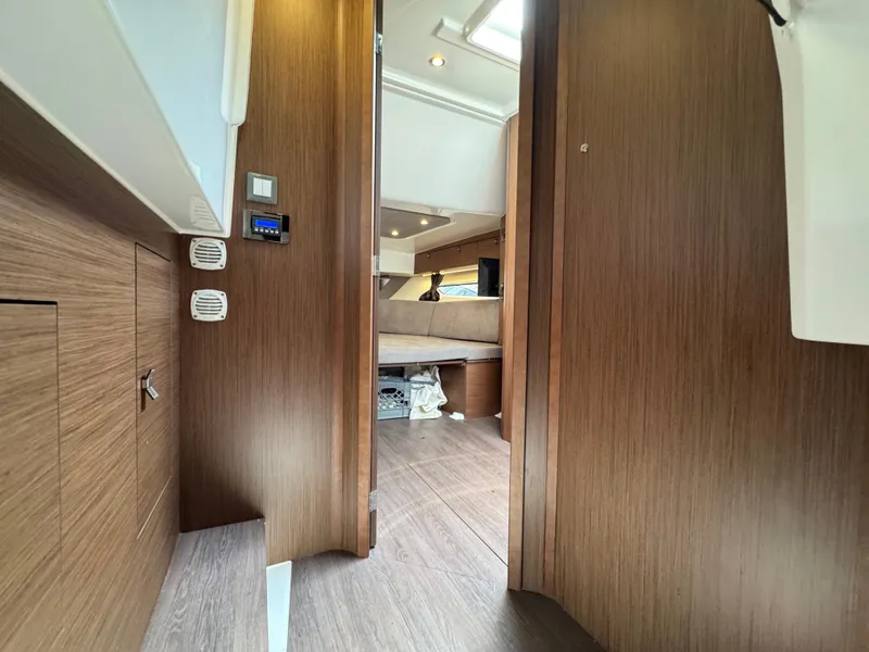 Slide: The Image of Interior view of 2022 Beneteau Gran Turismo 32 yacht, featuring wood paneling and modern design. - 32