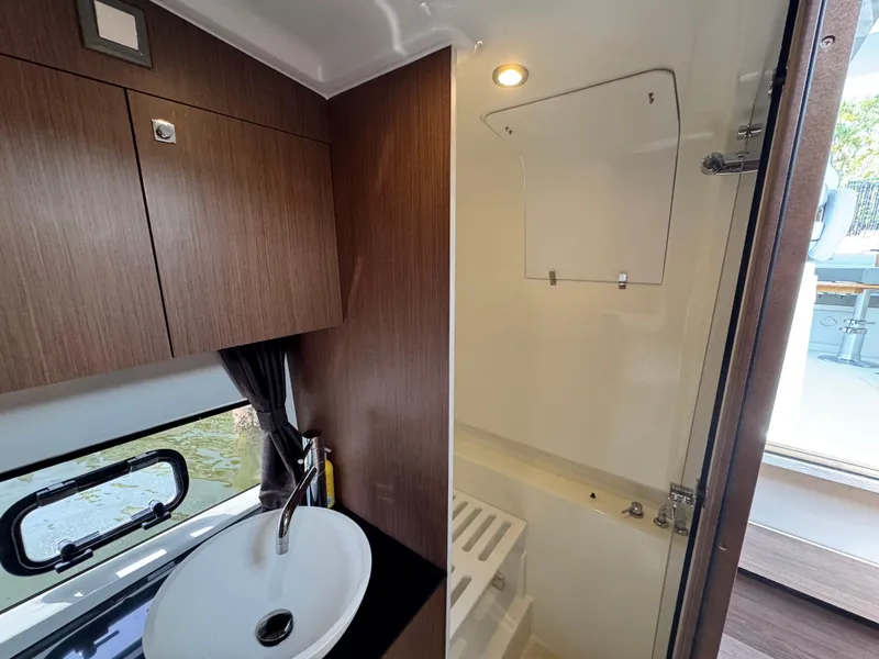 Slide: The Image of Interior of 2022 Beneteau Gran Turismo 32 yacht bathroom with sink and shower. - 34