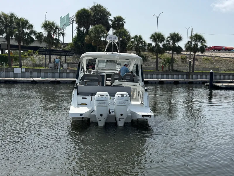 Slide: The Image of 2022 Beneteau Gran Turismo 32 yacht docked, featuring dual outboard engines. - 7