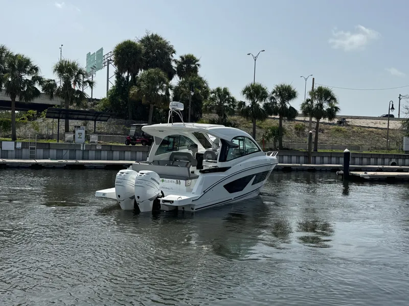 Slide: The Image of 2022 Beneteau Gran Turismo 32 yacht on calm water with palm trees in background. - 8