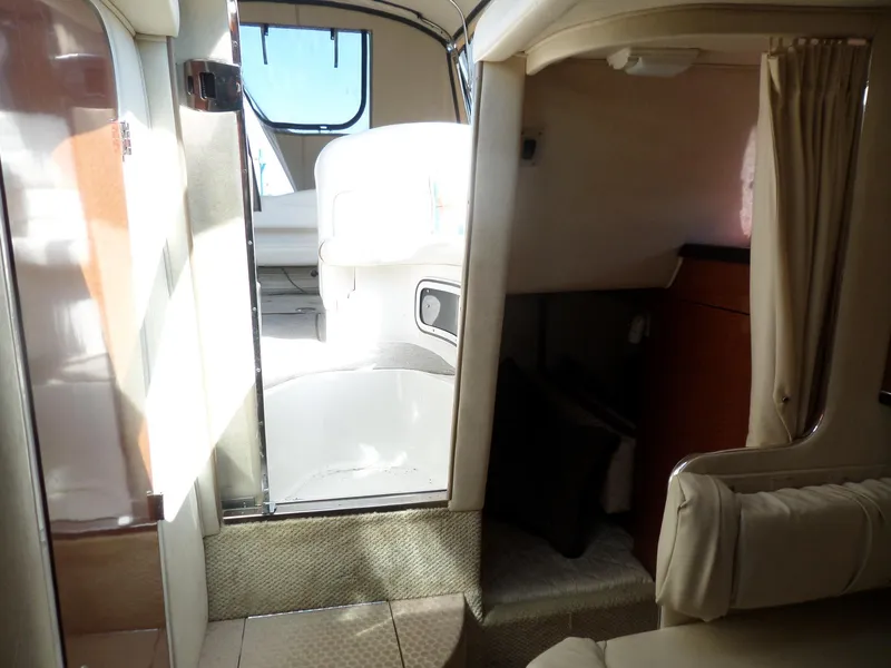 Slide: The Image of Interior of 2003 Sea Ray 280 Sundancer boat, featuring seating and cabin area. - 28