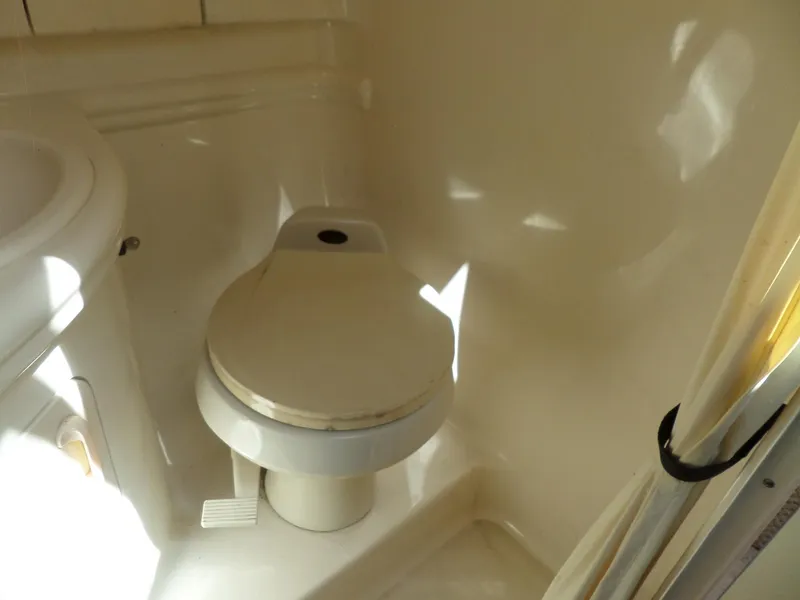 Slide: The Image of 2003 Sea Ray 280 Sundancer bathroom with compact marine toilet. - 33