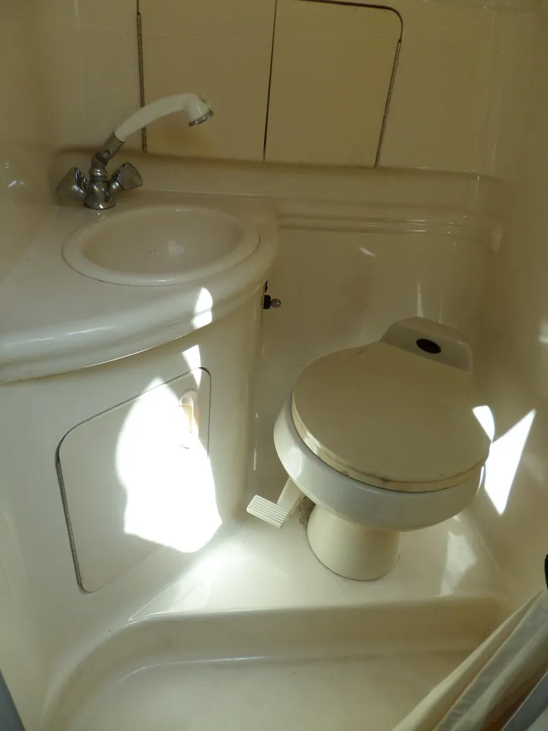 Slide: The Image of 2003 Sea Ray 280 Sundancer bathroom with sink and toilet. - 35
