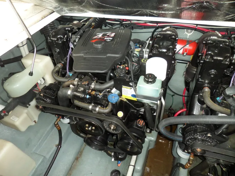 Slide: The Image of Engine compartment of a 2003 Sea Ray 280 Sundancer boat, showcasing dual engines and components. - 38