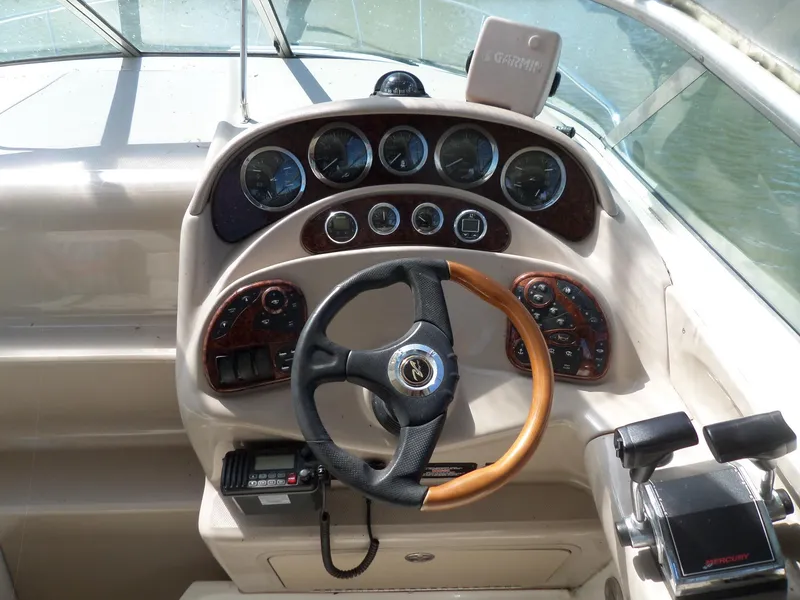 Slide: The Image of 2003 Sea Ray 280 Sundancer dashboard with steering wheel and instrument panel. - 6