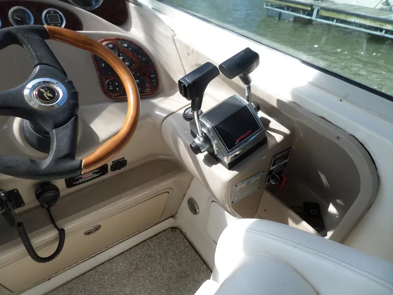 Slide: The Image of 2003 Sea Ray 280 Sundancer helm with steering wheel and controls. - 7