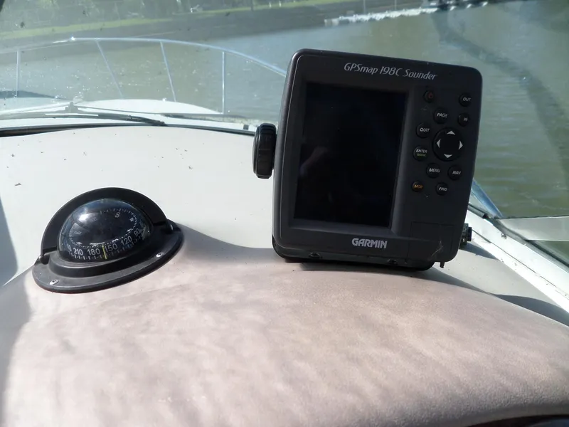 Slide: The Image of Compass and Garmin GPS on 2003 Sea Ray 280 Sundancer boat dashboard. - 9