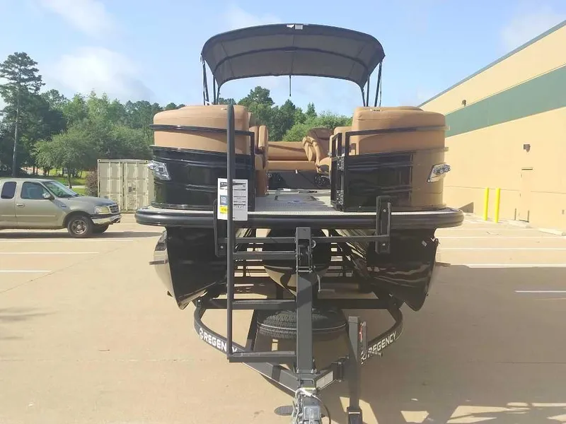 Slide: The Image of 2025 Regency 250 LE3 Sport pontoon boat on trailer in parking lot. - 3
