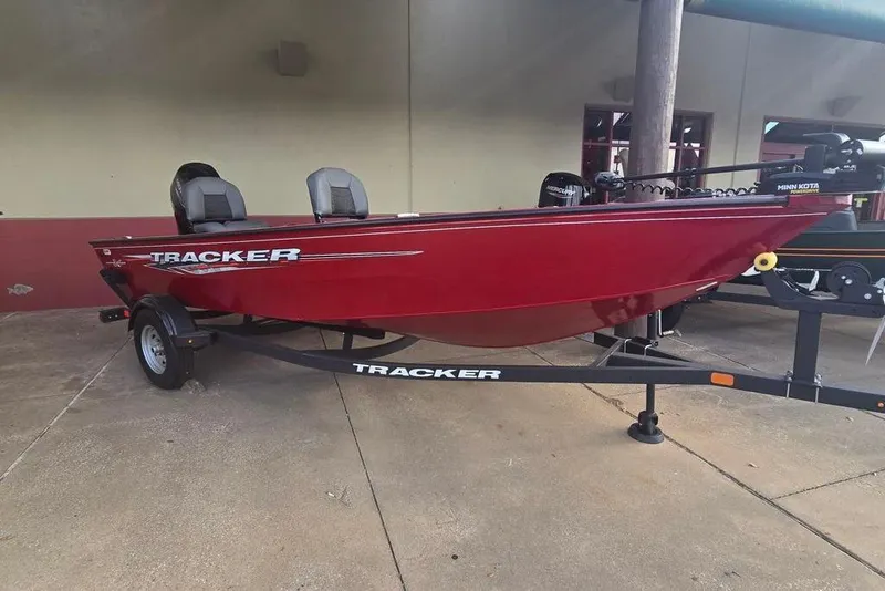 The Image of 2025 Tracker Super Guide V-16 T boat in red on a trailer. - 0
