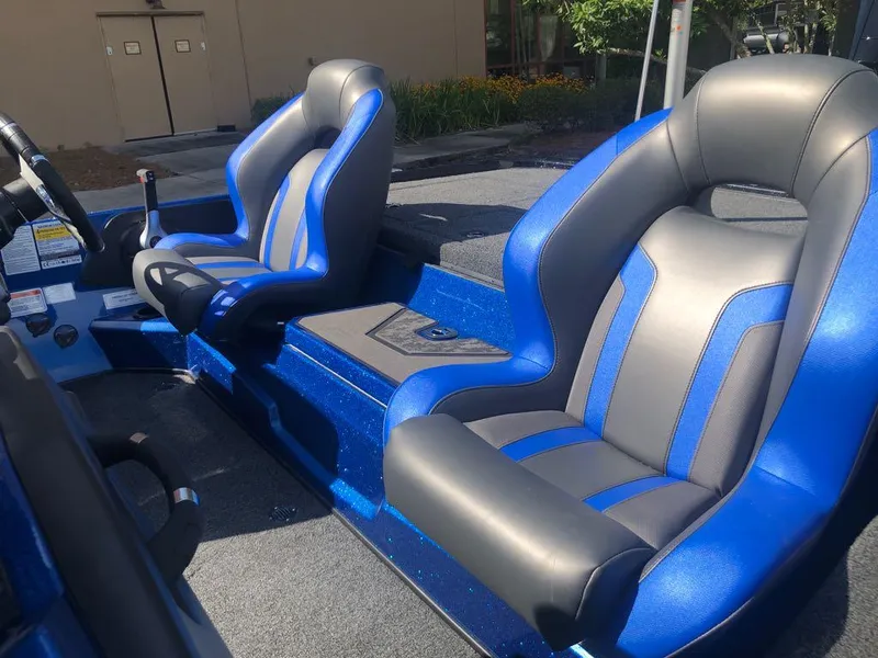 Slide: The Image of 2025 Nitro Z20 XL boat interior with blue and gray seats, steering wheel visible. - 12