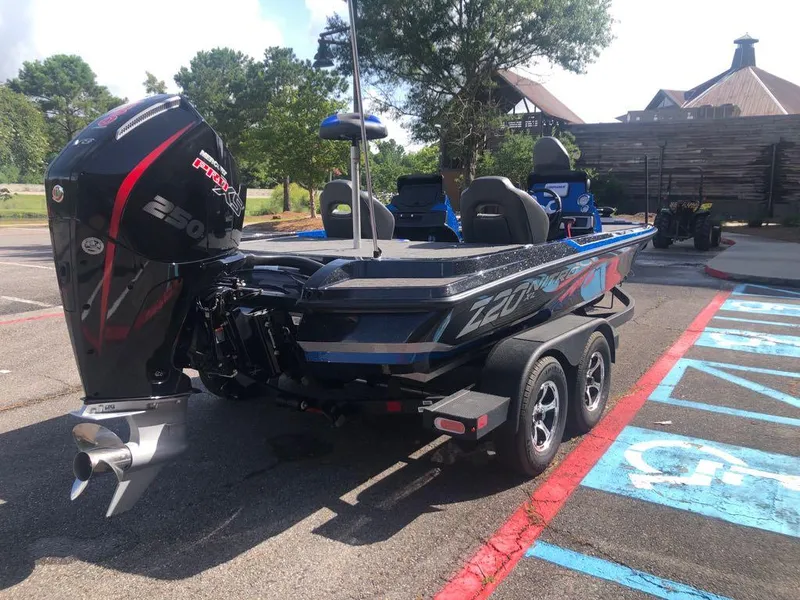Slide: The Image of 2025 Nitro Z20 XL boat with powerful outboard motor in a parking lot. - 4