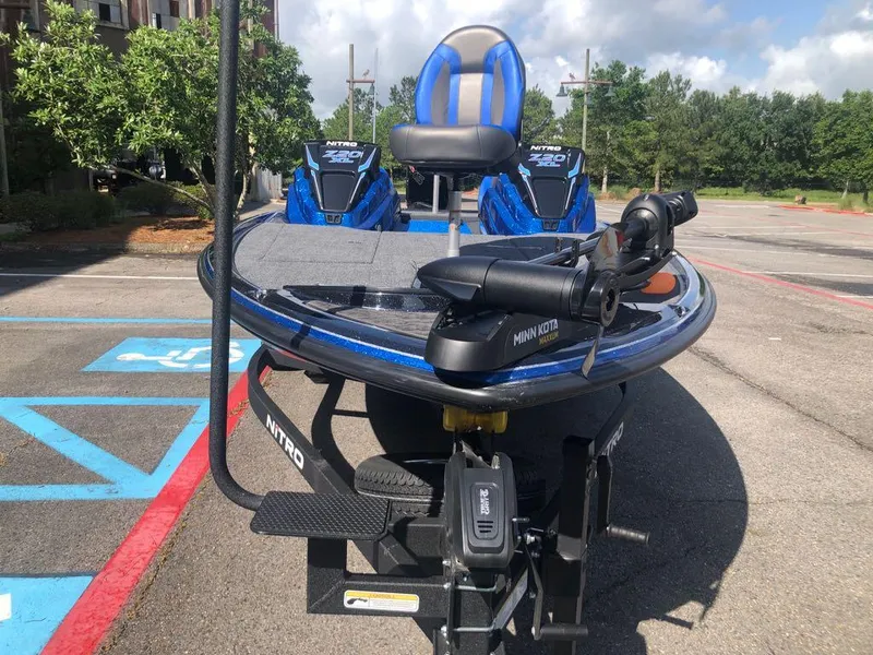 Slide: The Image of 2025 Nitro Z20 XL boat with Minn Kota motor in a parking lot. - 7