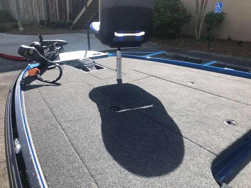 Slide: The Image of 2025 Nitro Z20 XL boat deck with seat and trolling motor in parking area. - 9