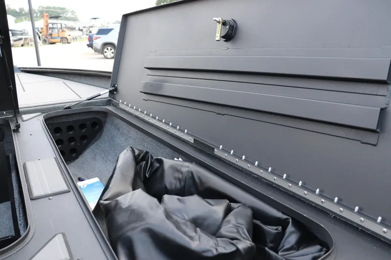 Slide: The Image of Open storage compartment in 2025 Tracker Savage 215 boat, showcasing interior design and features. - 10