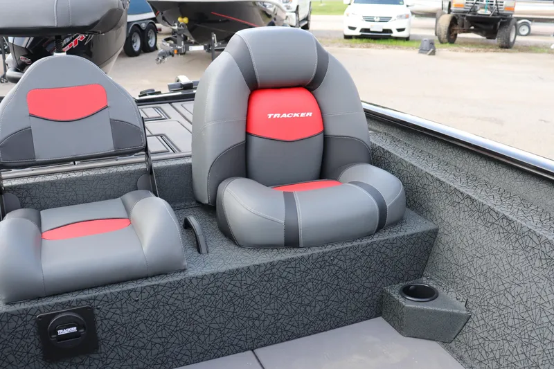 Slide: The Image of 2025 Tracker Savage 215 boat interior with gray and red cushioned seats. - 14