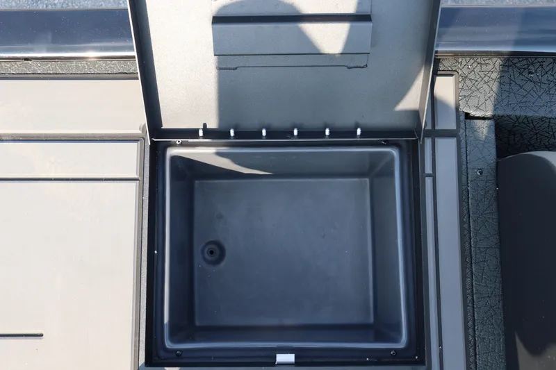 Slide: The Image of Open storage compartment on 2025 Tracker Savage 215 boat deck. - 18