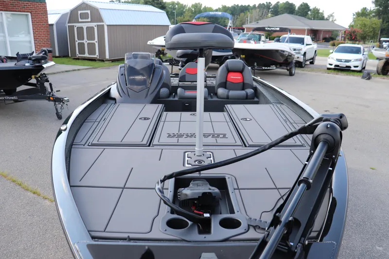 Slide: The Image of 2025 Tracker Savage 215 boat with sleek deck design and modern seating. - 3