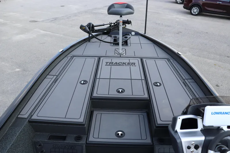 Slide: The Image of 2025 Tracker Savage 215 boat deck with storage compartments and trolling motor. - 4