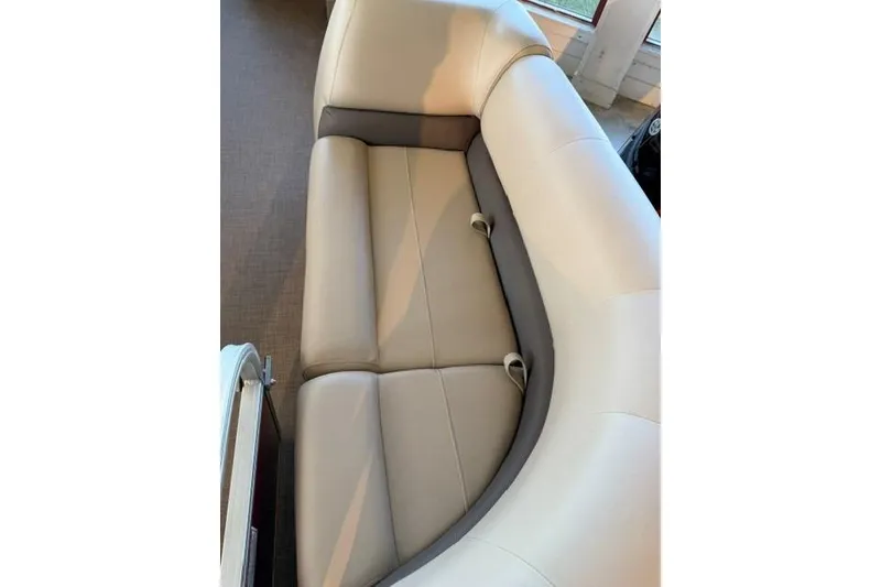 Slide: The Image of 2025 Sun Tracker Party Barge 18 DLX interior seating, featuring beige and gray upholstery. - 6