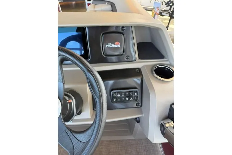 Slide: The Image of 2025 Sun Tracker Party Barge 18 DLX dashboard with steering wheel and control panel. - 13