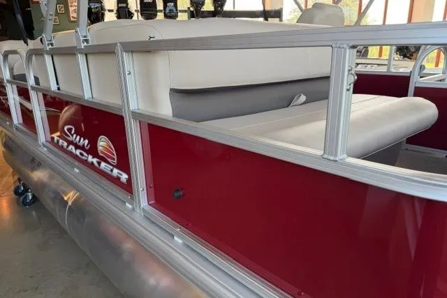 Slide: The Image of 2025 Sun Tracker Party Barge 18 DLX pontoon boat with red exterior and white seating. - 3
