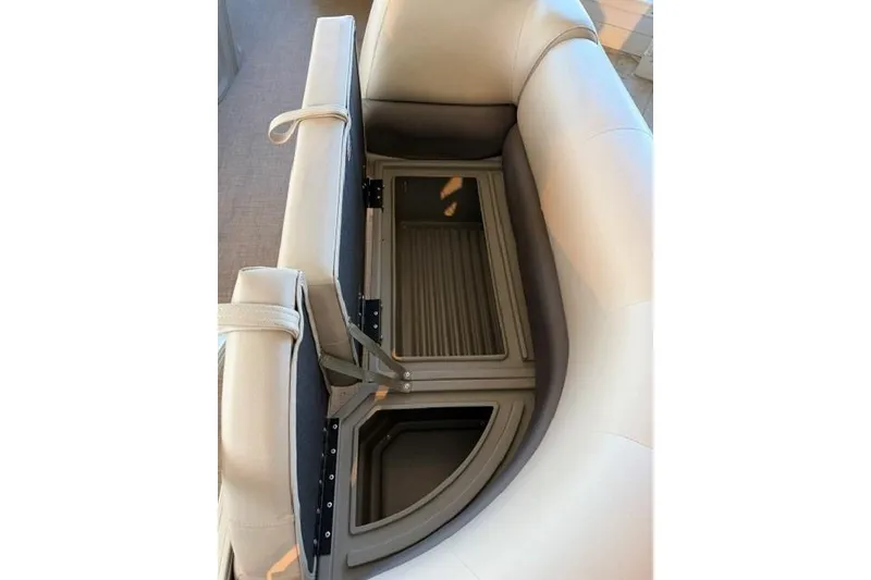 Slide: The Image of 2025 Sun Tracker Party Barge 18 DLX interior storage compartment with open seating. - 7