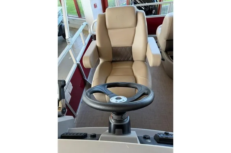 Slide: The Image of Captain's chair and steering wheel of 2025 Sun Tracker Party Barge 18 DLX pontoon boat. - 15