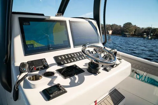 Slide: The Image of Control panel of 2026 Front Runner 36 cc boat with navigation screens and steering wheel. - 11
