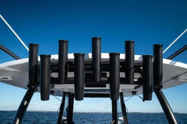 Slide: The Image of Rooftop rod holders on 2026 Front Runner 36 cc boat against clear blue sky. - 16