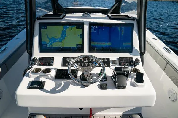 Slide: The Image of 2026 Front Runner 36 cc boat dashboard with dual navigation screens and controls. - 19