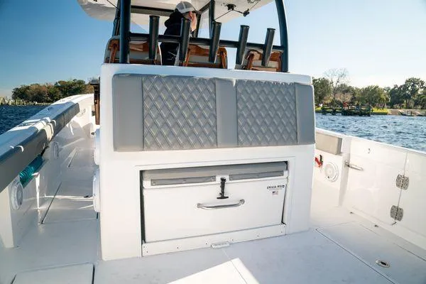 Slide: The Image of 2026 Front Runner 36 cc boat interior with seating and storage on a sunny day. - 23