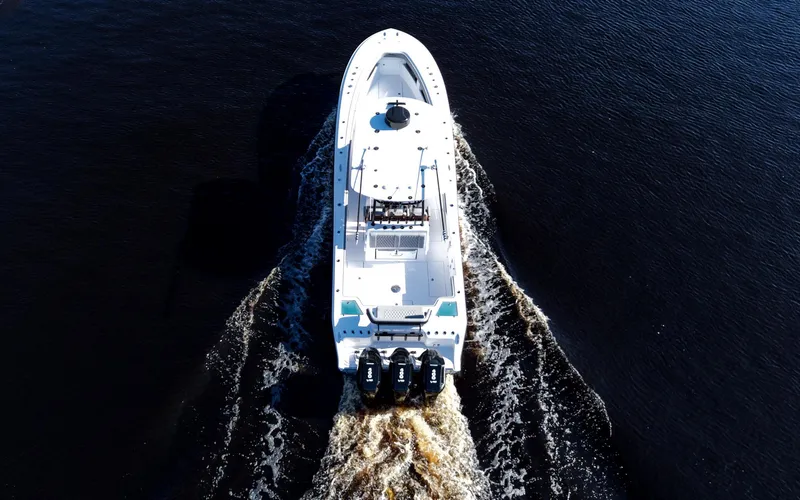 Slide: The Image of Aerial view of 2026 Front Runner 36 cc boat cruising on dark water. - 5