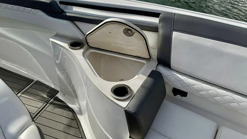 Slide: The Image of Luxury seating area on a 2020 Fountain 43NX boat with cup holders and storage. - 10