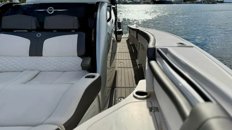 Slide: The Image of Luxury Fountain 43NX boat interior with sleek seating, docked by the water. - 15
