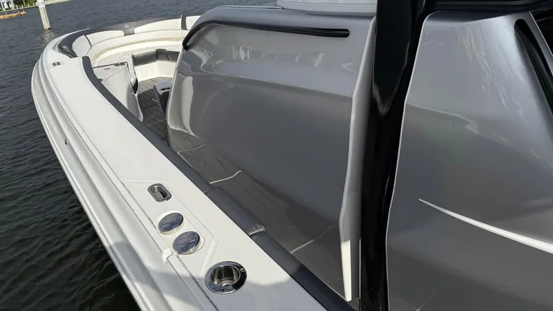 Slide: The Image of 2020 Fountain 43NX boat, sleek design, white and gray exterior, docked on water. - 18