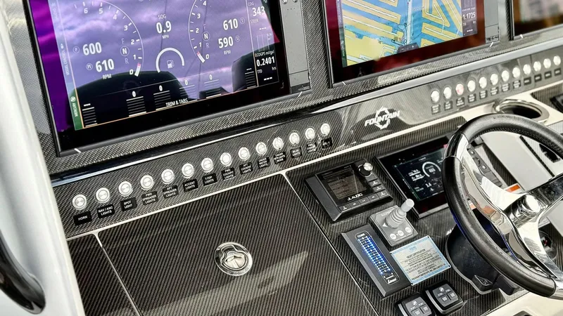 Slide: The Image of Dashboard of a 2020 Fountain 43NX boat with digital displays and controls. - 25