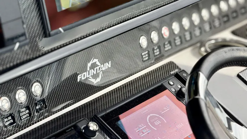 Slide: The Image of Dashboard of 2020 Fountain 43NX boat with control panel and steering wheel. - 26