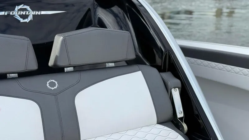 Slide: The Image of 2020 Fountain 43NX boat interior with gray and white seating, near water. - 30