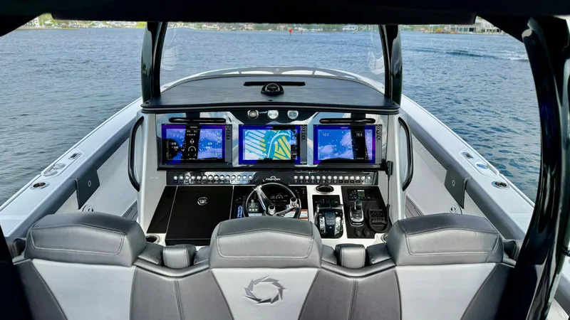Slide: The Image of Cockpit of 2020 Fountain 43NX boat with advanced navigation displays on open water. - 36