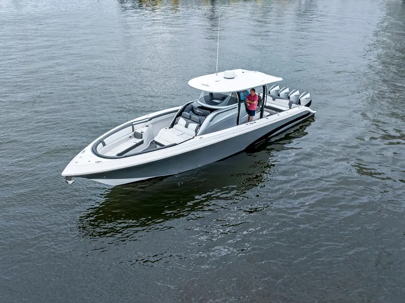 Slide: The Image of 2020 Fountain 43NX boat on calm water, featuring sleek design and multiple outboard engines. - 4