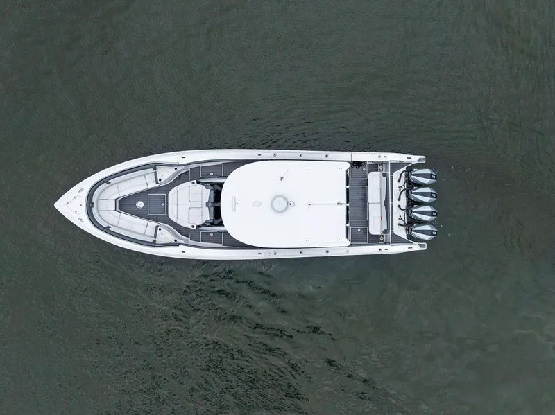 Slide: The Image of Aerial view of 2020 Fountain 43NX boat on water, showcasing sleek design and multiple engines. - 6