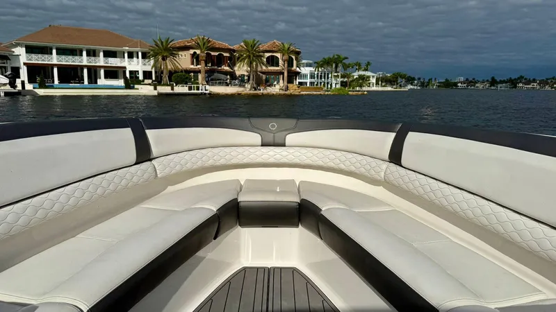 Slide: The Image of Luxury seating on a 2020 Fountain 43NX boat with waterfront view. - 7