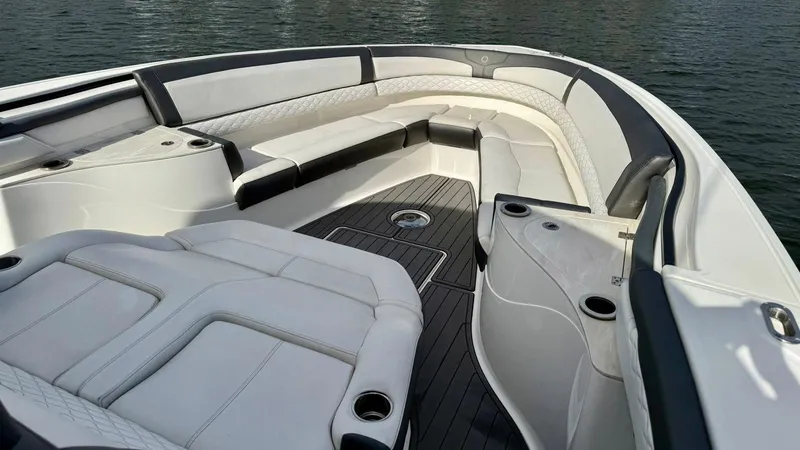 Slide: The Image of Luxurious seating area on a 2020 Fountain 43NX boat, featuring sleek white upholstery. - 8