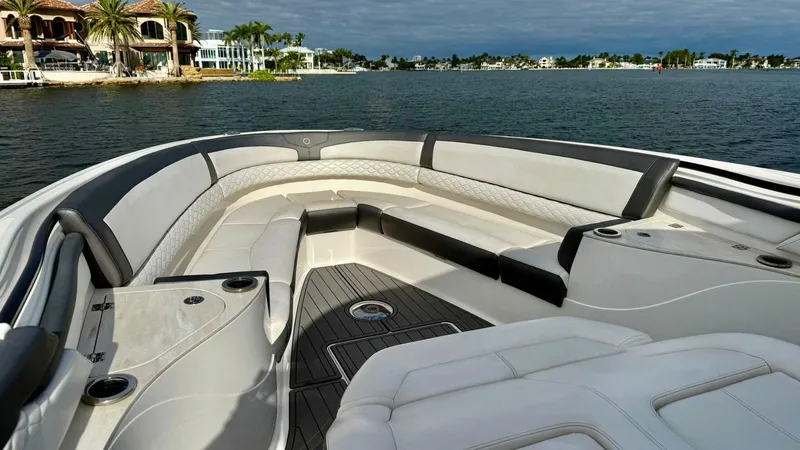 Slide: The Image of Luxury seating on a 2020 Fountain 43NX boat with scenic waterfront view. - 9