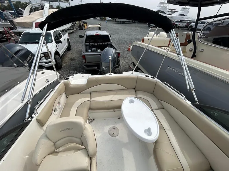 Slide: The Image of 2021 NauticStar 203 DC boat with beige seating and a small table. - 10