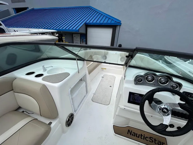 Slide: The Image of 2021 NauticStar 203 DC boat interior with steering wheel and seating. - 7
