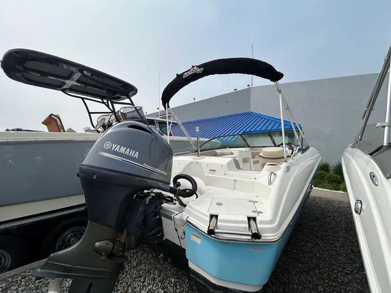 The Image of 2021 NauticStar 203 DC boat with Yamaha engine, parked on gravel. - 0
