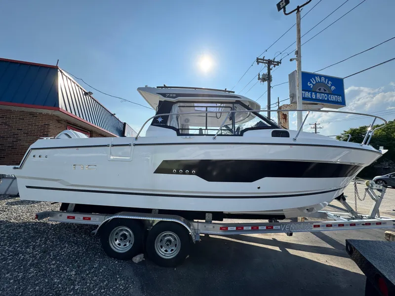 The Image of 2025 Jeanneau NC 795 Series 2 boat on trailer at Sunrise Tire & Auto Center. - 0