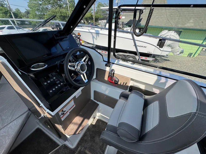 Slide: The Image of 2025 Jeanneau NC 795 Series 2 helm with modern controls and comfortable seating. - 10